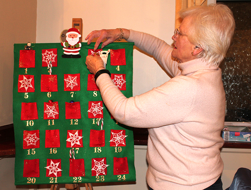 Betty setting up the Advent Calendar on an easel