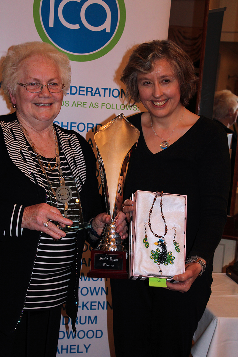 Madge Kenny, Wicklow Federation President stands with Susanna who holds a box containing her handmade peacock pendant and earrings